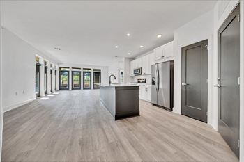 A modern kitchen with a large island and stainless steel appliances.